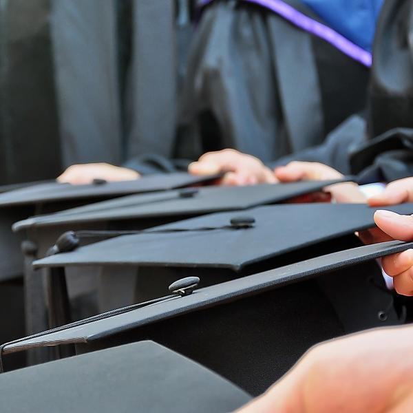 A row of graduates wearing caps