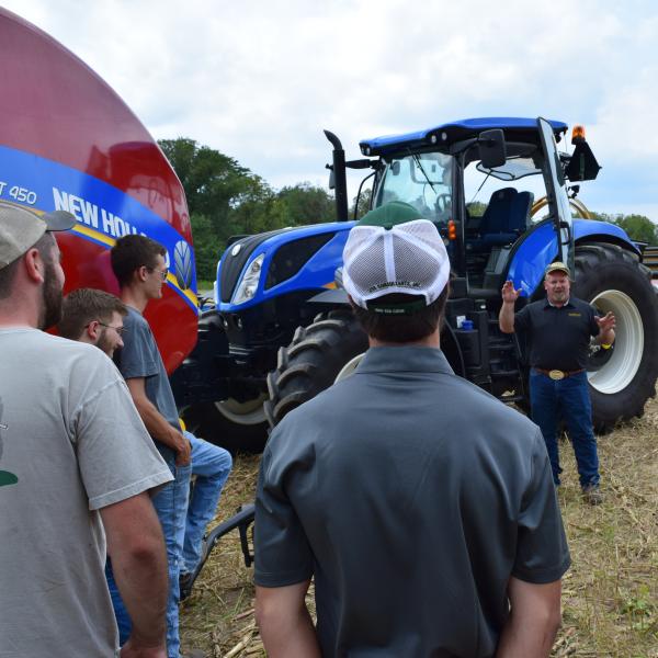 In the field classroom with heavy farm equipment.