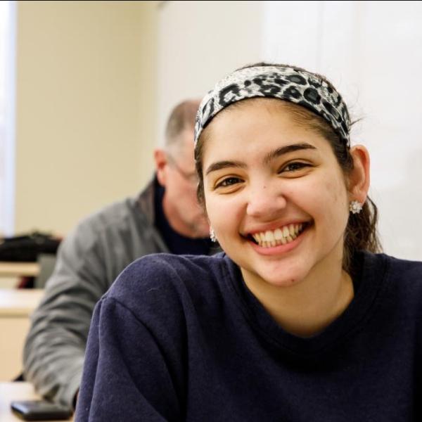 A young woman smiling in class