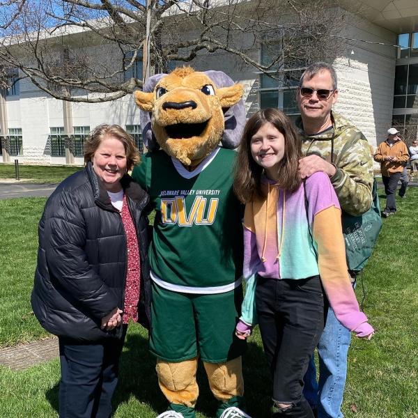 A family poses with Caesar for Accepted Students Week
