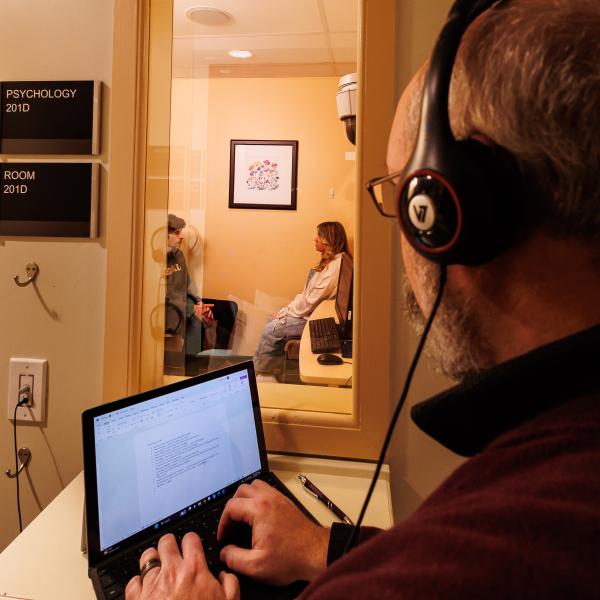 Dr. Matt Mutchler is working with two students in the counseling psychology lab. 