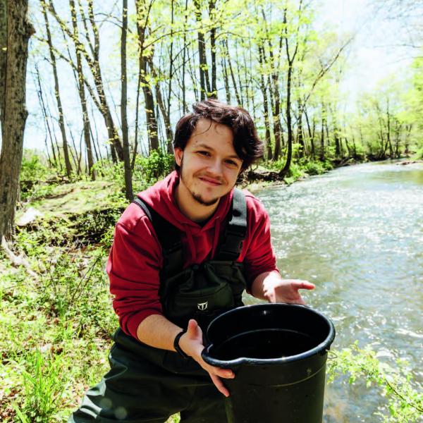 Jessie Edwards at Lake Archer with a bucket in his hand. 