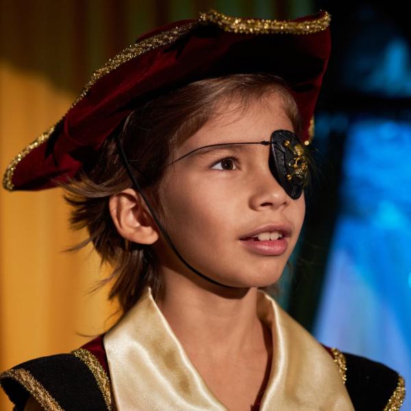 A child is dressed as a pirate with pirate hat and eye patch.