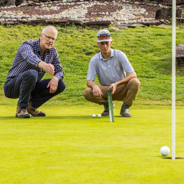 A Turf Management course with Doug Linde is occuring on a golf course.