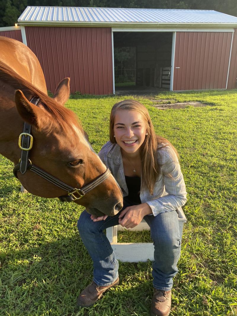 Jalene Beach '21, an animal science student at Delaware Valley University, with a horse.
