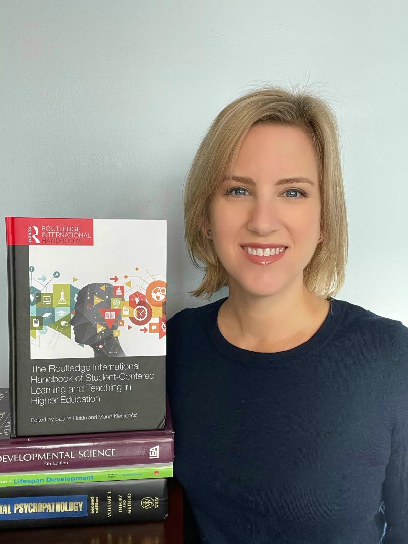 Dr. Allison Buskirk-Cohen,  professor of psychology and chair of the undergraduate Department of Psychology at Delaware Valley University holds a copy of the new “Routledge International Handbook of Student-Centered Learning and Teaching in Higher Education.”