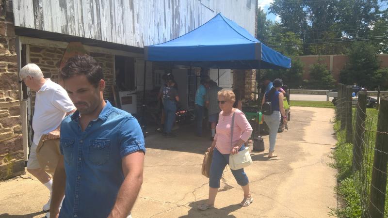 Community members visit a farm market run by DelVal students. =