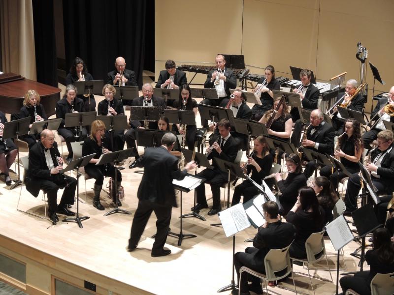 The DelVal Symphonic Band and Jazz Band plays instruments on stage. 