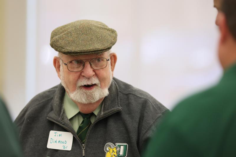 A close-up of Dr.Diamond speaking to alumni council meeting members.