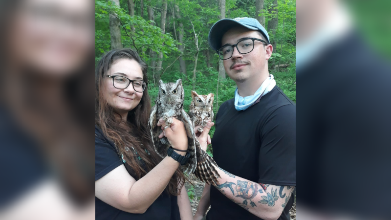 Jacob Miranda holding an owl with a classmate