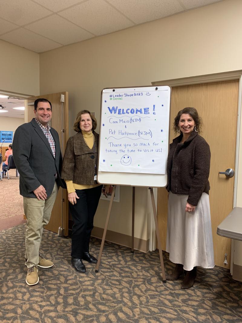 DelVal donors pose for a photo in front of a board that says welcome!