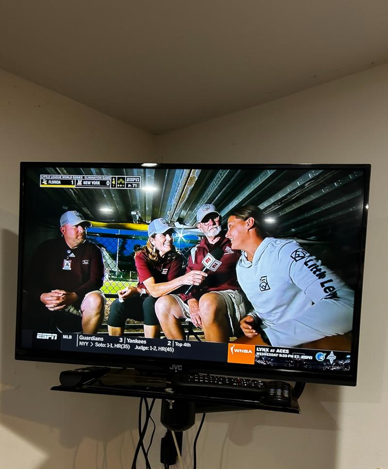A picture of a tv screen with Jillian being interviewed by the news.