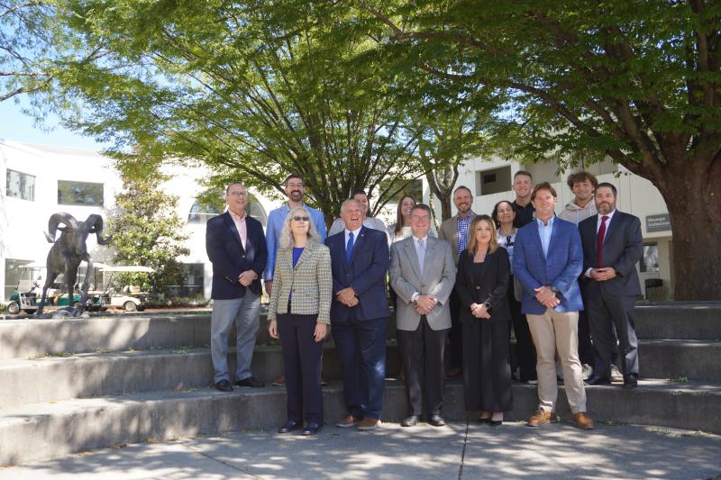 Officials and students from NCC and DVU gather beside the DelVal Caesar statue to celebrate their new partnership