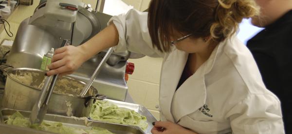 Woman preparing food in a test kitchen
