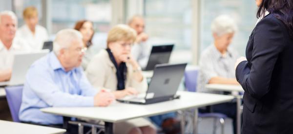 Elderly students learning in a classroom