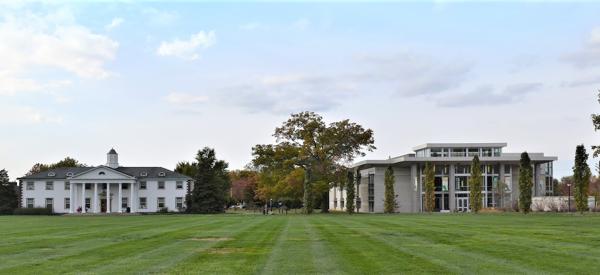 The quad at DelVal: a lush green field with two buildings.