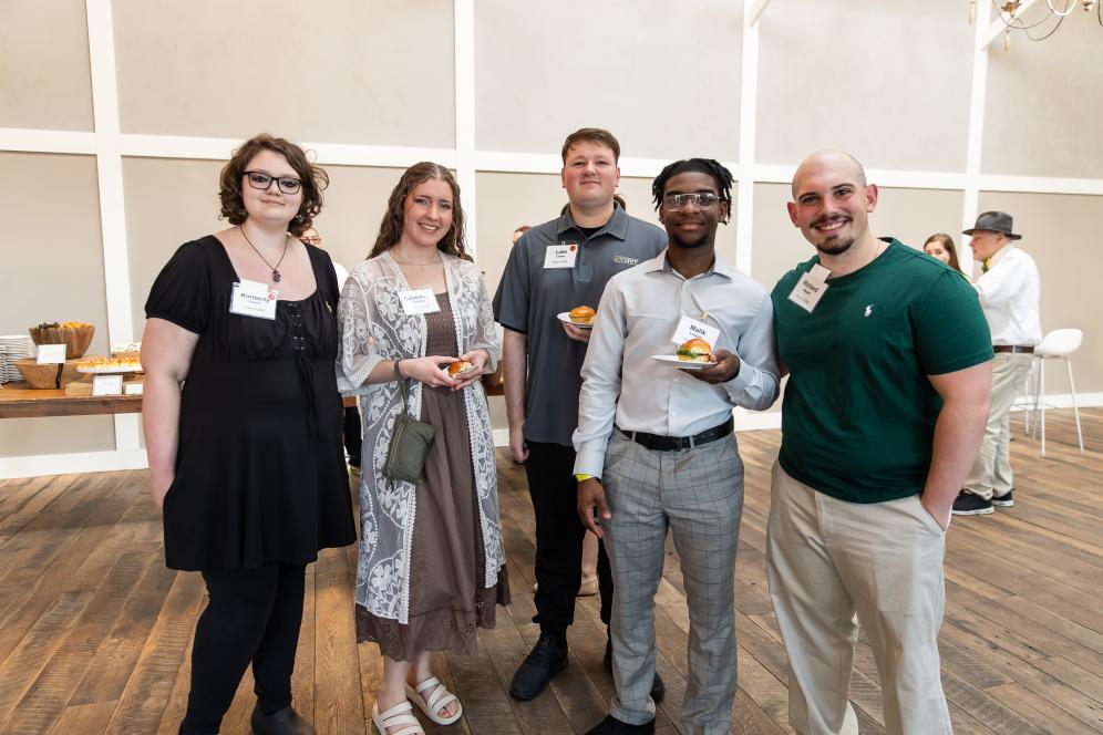 five DelVal Student Scholarship Recipients are smiling together for a photo.